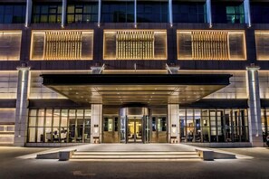 A modern hotel entrance with a revolving door, large windows, and a covered entrance area. - Chengde Hotel (Mountain Resort) (Chengde)