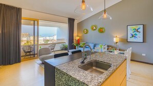 A modern kitchen with a granite countertop, stainless steel sink, and pendant lighting. - Scala 306 1BD Condo for rent in Old Town, Puerto vallarta (Puerto Vallarta)