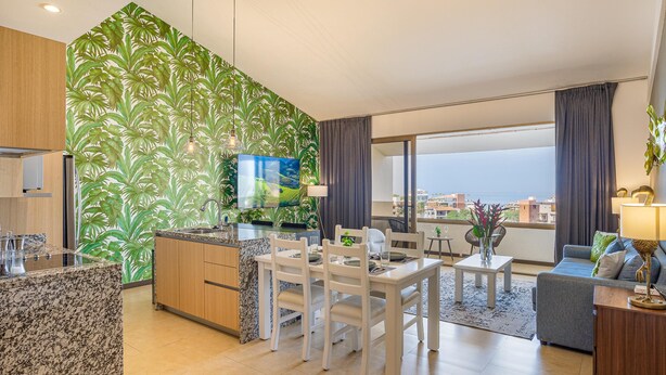 A modern living room with a kitchen, dining area, and a balcony with a view. - Scala 306 1BD Condo for rent in Old Town, Puerto vallarta (Puerto Vallarta)