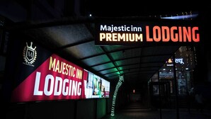 A corridor with a sign for Majestic Inn Premium Lodging. - Majestic Inn (Pune)