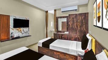 A hotel room with a bed, a TV, a mirror, and a wardrobe.