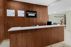 A reception desk with a sign that reads 'TOWNHOUSE OYO-Serviced'. - Classic Hotel Lakshmi's Pride (Kurnool)