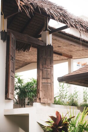 A traditional wooden structure with thatched roofing, likely part of a hotel or resort. - Charming 2-BR Seaside Haven (Ko Pha-ngan)