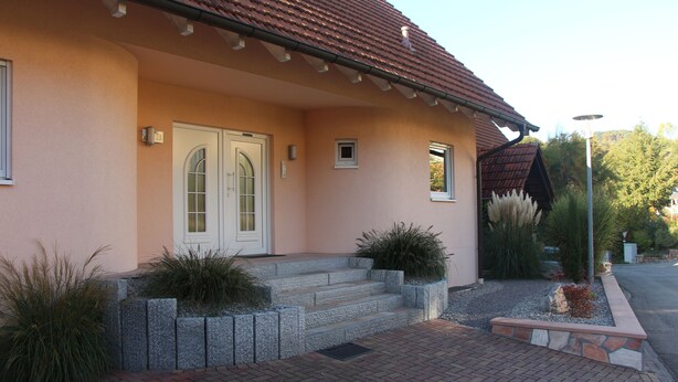 A house with a red-tiled roof, a two-door entrance, and a brick pathway leading to the front steps. - Brack vacation apartments in Gaggenau (Gaggenau)