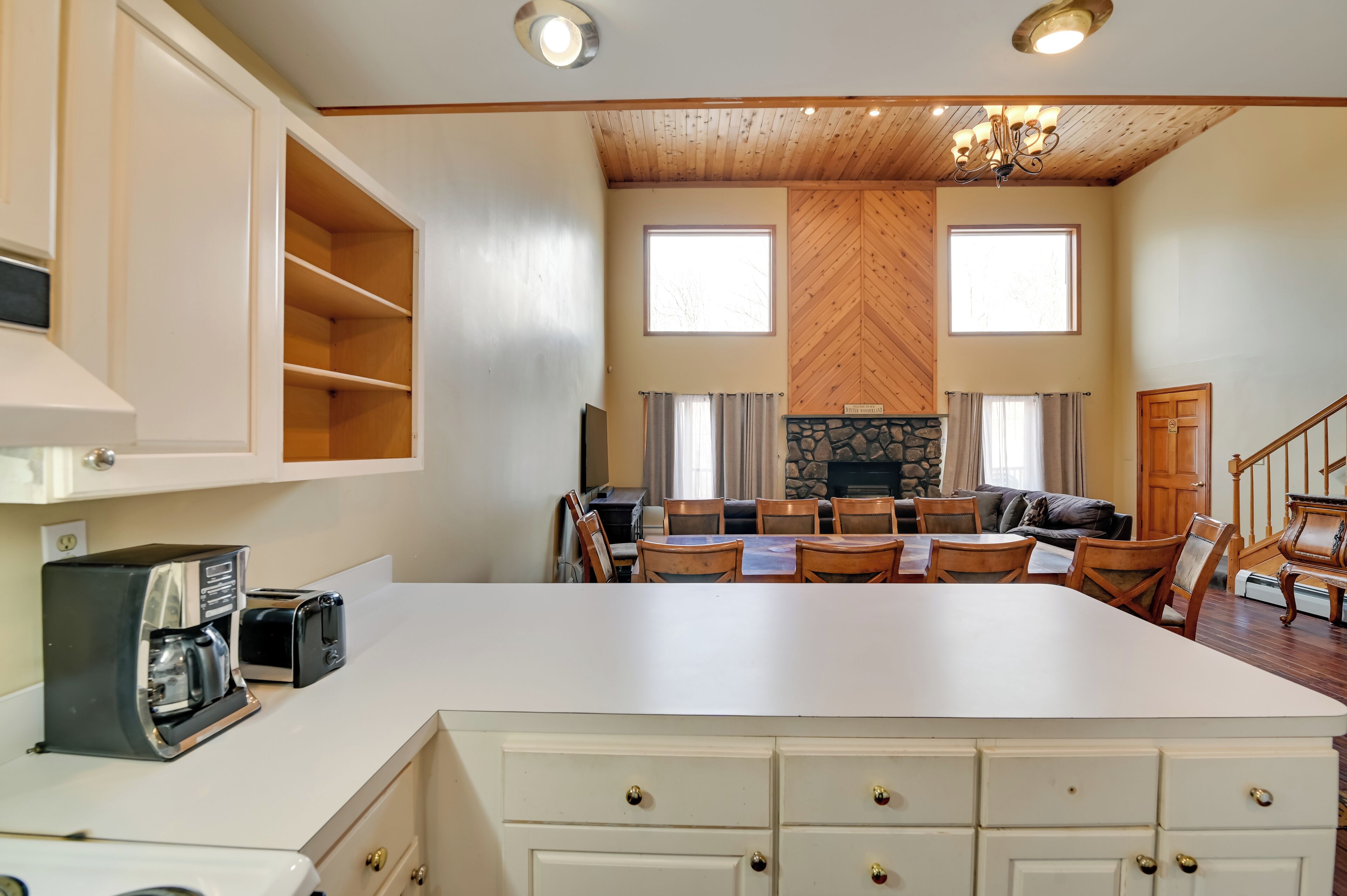A spacious living area with a fireplace, dining table, and comfortable seating.