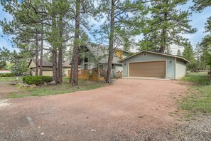 A two-story house with a gravel driveway and a garage. - Forest-front Munds Park Cabin w/ ATV Access (Munds Park)