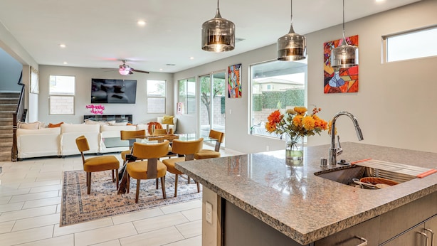 A modern kitchen with granite countertops, a built-in sink, and pendant lighting. - 11 Mi to the Strip: Quiet Home in North Las Vegas (North Las Vegas)