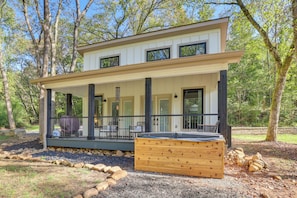 A modern two-story house with a covered porch, outdoor seating, and a hot tub. - Whitewood w/ Hot Tub: Peaceful Wildwood Retreat (Wildwood)