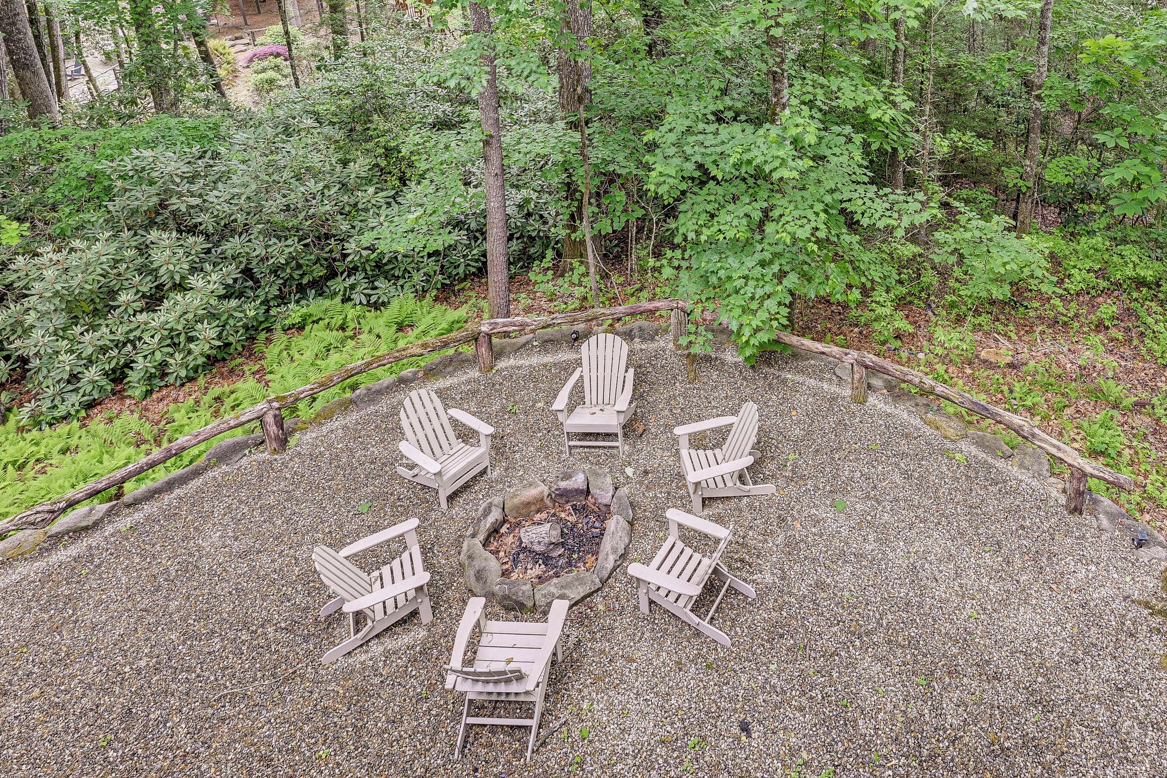 A circular seating arrangement around a fire pit in a forested area.
