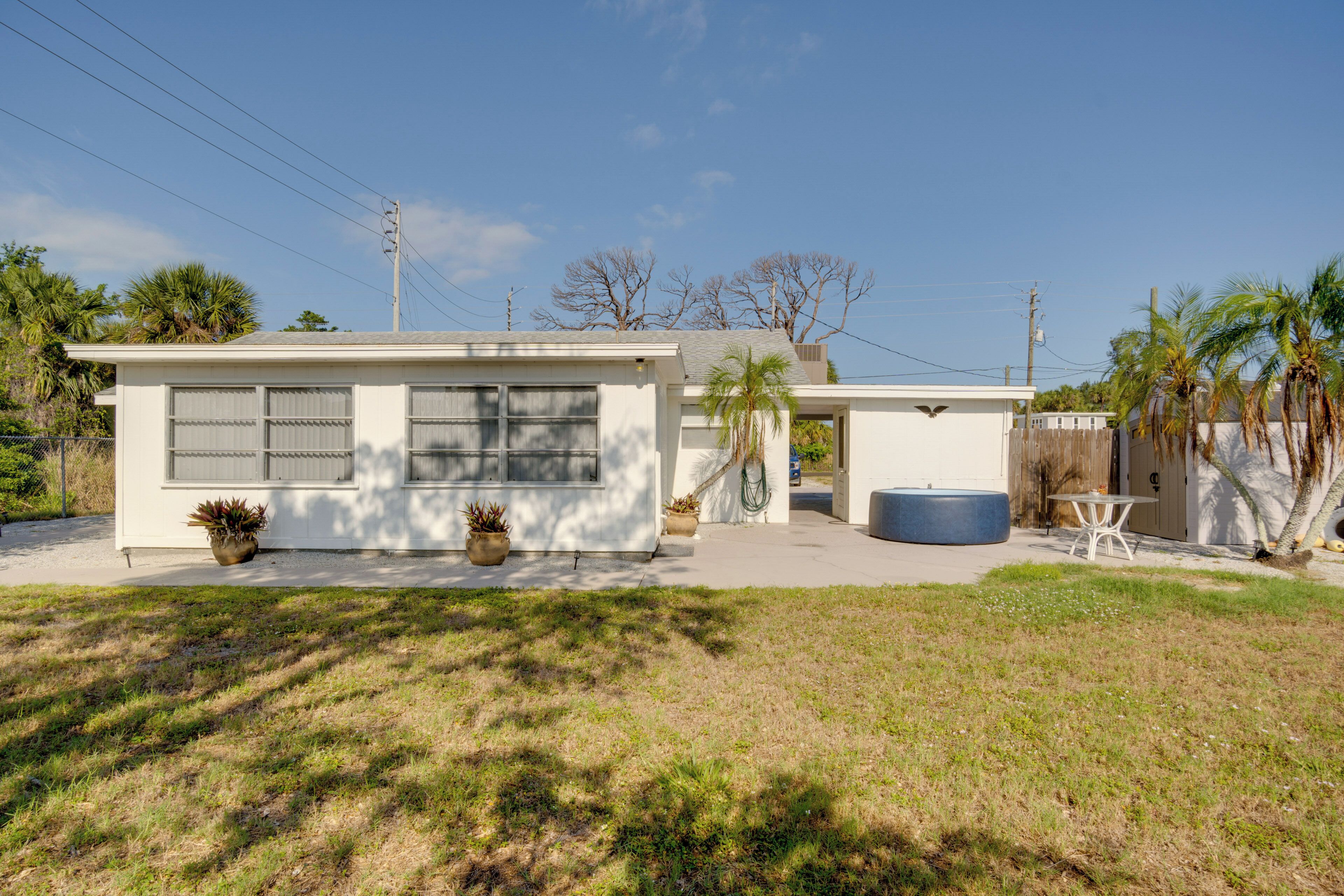 A single-story house with a garage, a front porch, and a small patio area.