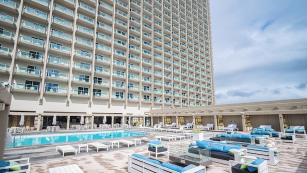 A large hotel with a rooftop pool area featuring sun loungers and a swimming pool. - Junior Suite 1 Bedroom Ala Moana Condominium, City / Partial Ocean from Lanai (Honolulu)