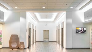 A modern hallway with a skylight, wooden flooring, and a framed artwork on the wall. - Junior Suite 1 Bedroom Ala Moana Condominium, City / Partial Ocean from Lanai (Honolulu)