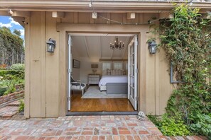 A bedroom with a wooden floor, a bed, a nightstand, and a dresser. - 4003 Casanova Sanctuary, Stunning Carmel Home (Carmel)