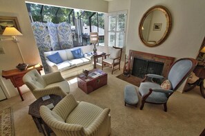 A living room with a sofa, armchairs, a coffee table, a fireplace, and a large mirror. - 4023 Monte Verde Sanctuary - Sweet Carmel Home (Carmel)