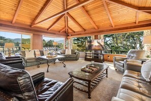 A spacious living area with leather sofas, a coffee table, and a fireplace. - 4045 Mission Hill ~ Mission Ranch, Point Lobos View (Carmel)