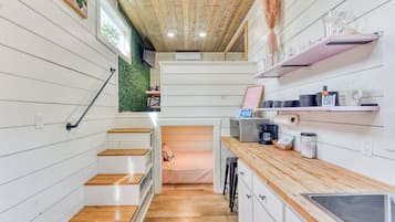 Fridge, microwave, coffee/tea maker, cookware/dishes/utensils