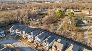 A residential area with detached houses, a main road, and a park. - The Encore - 2 mi to Amp - 1 mi to Promenade (Rogers)