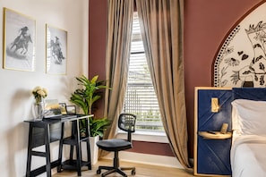 A bedroom with a bed, a desk with a chair, a window with curtains, and two framed pictures on the wall. - 2BR/2BA near Universal Kids, sleeps 6, patio (Frisco)