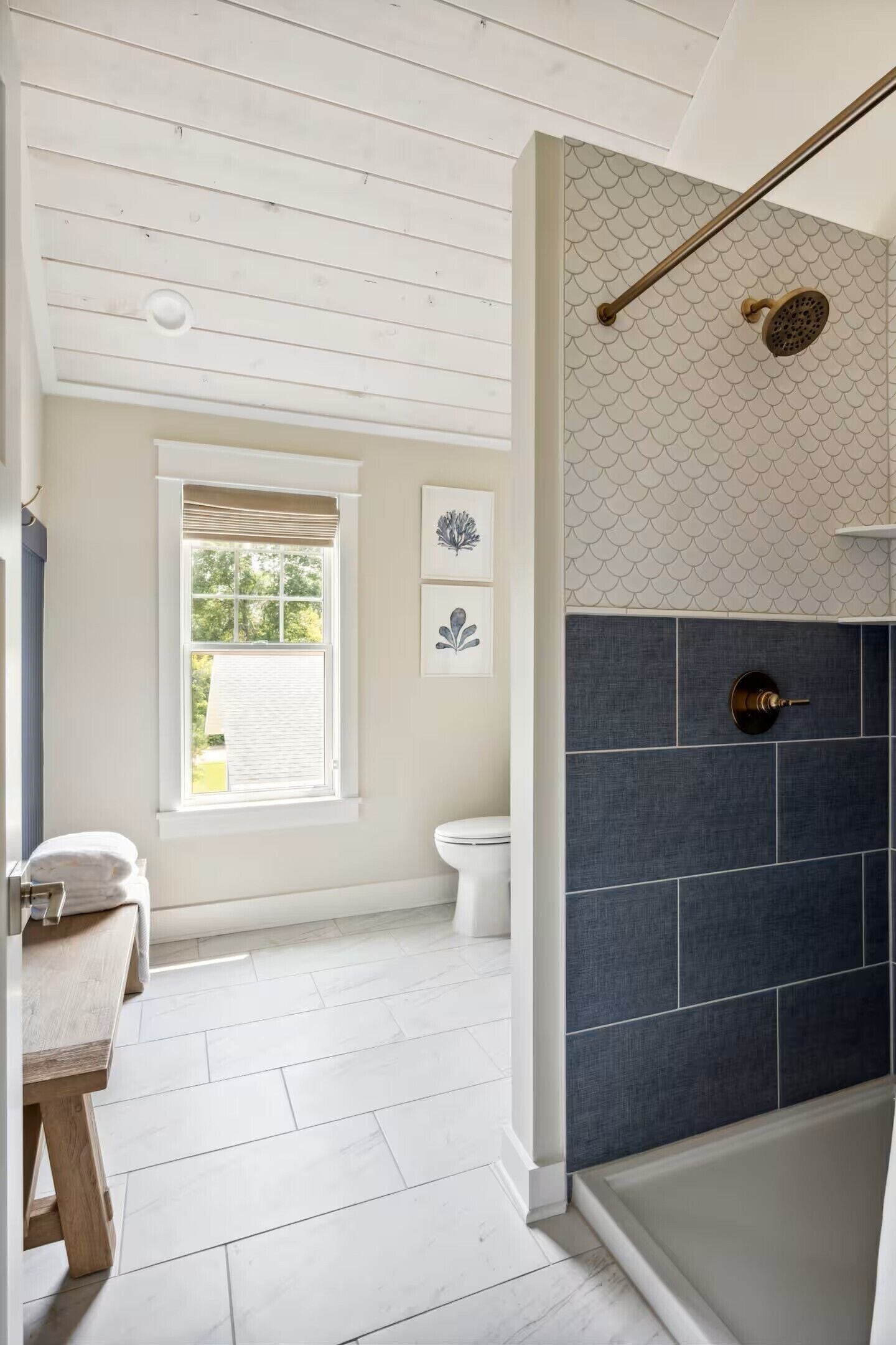 A bathroom with a shower, toilet, and sink.