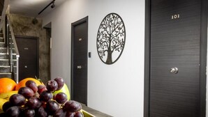 A room with a staircase, a door labeled 101, and a wall-mounted tree decoration. - Boutique accommodation with pool and sea views. 20 guests! (Benalmádena)