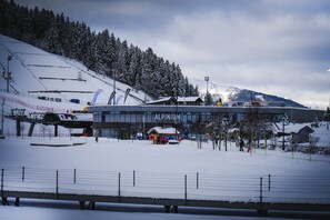 A snow-covered ski resort with a prominent building labeled 'ALPINE'. - The Courchevel Nests: APT 13, Le Praz (Courchevel)