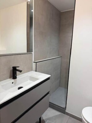 A modern bathroom with a white sink, a mirror, and a shower area. - The Courchevel Nests: APT 13, Le Praz (Courchevel)