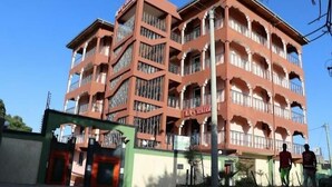 A multi-story building with balconies and a sign that reads "LA FAMOUS". - Latahzan Guest House (Moyale)