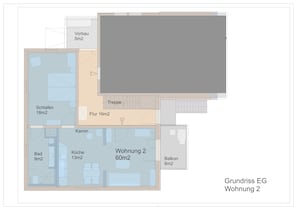 A floor plan of a building with labeled rooms including a living room, kitchen, bathroom, and balcony.