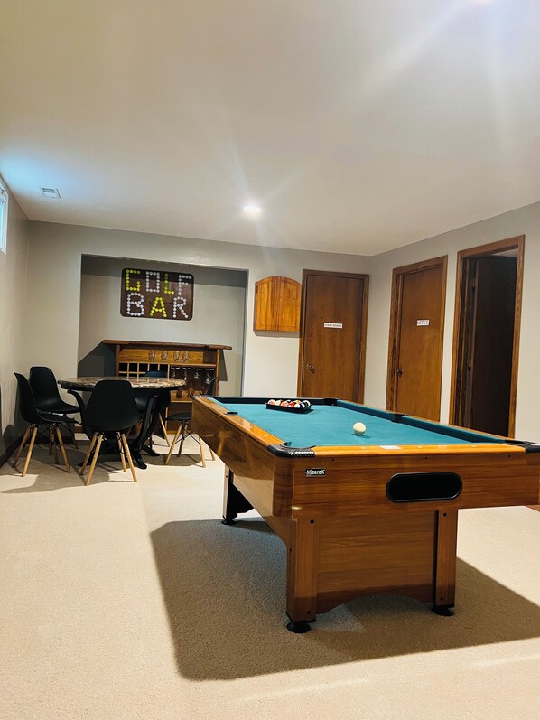 A pool table in a room with a bar area, wooden cabinets, and a sign that reads "BAR". - Spacious 3BR/3BA Home with Two Extra Rooms and Equipped Gym (Lincoln)
