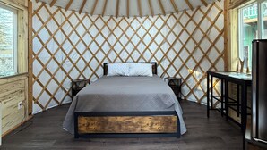 A room with a bed, a desk, and a window with a view. - Salmon Spot (Seward)