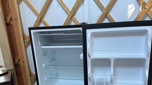 A refrigerator with a wooden frame, a glass door, and a built-in shelf. - Salmon Spot (Seward)