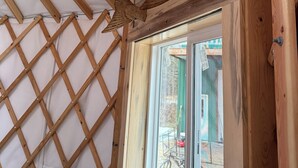 A wooden ceiling structure with a lattice design and a large window. - Salmon Spot (Seward)
