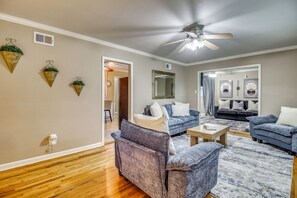 A living room with a ceiling fan, two sofas, a coffee table, and a patterned rug. - 2 Mi to Downtown Savannah: Historic Home! (Savannah)