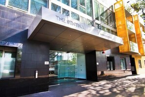 A modern building entrance with a glass door and a sign that reads 'THE SENTINEL.' - Lvl 27 2BR Southbank Apt | Melbourne Sky Views (Southbank)