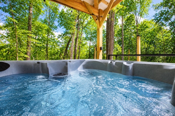 Private hot tub surrounded by trees — the perfect place to relax and unwind after a quiet day in nature