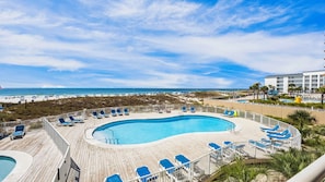A pool area with a view of the beach and ocean. - Coastal Comfort Sugar Beach | Direct Beach Access (Orange Beach)