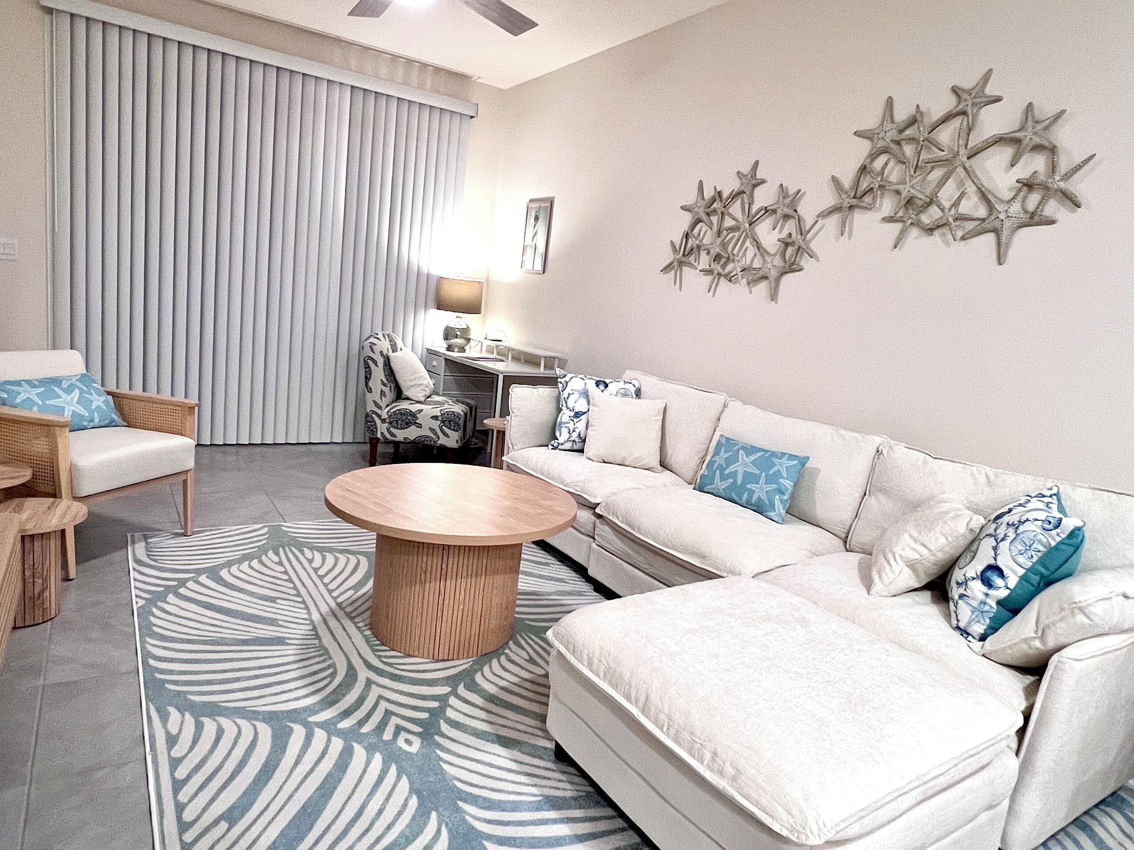 Living area leads out to patio with 2 chairs.
