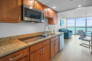 A modern kitchen with granite countertops, stainless steel appliances, and wooden cabinets. - Cozy Apartment at the Heart of Fort Myers (Fort Myers)