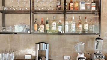 A bar area with shelves of liquor bottles and glasses.