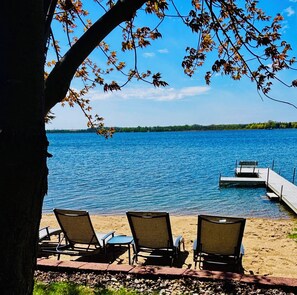 A lakeside view with chairs and a dock. - Sunset Beach Getaway - Game Room+XBox+Fire Pit+Fun (Detroit Lakes)