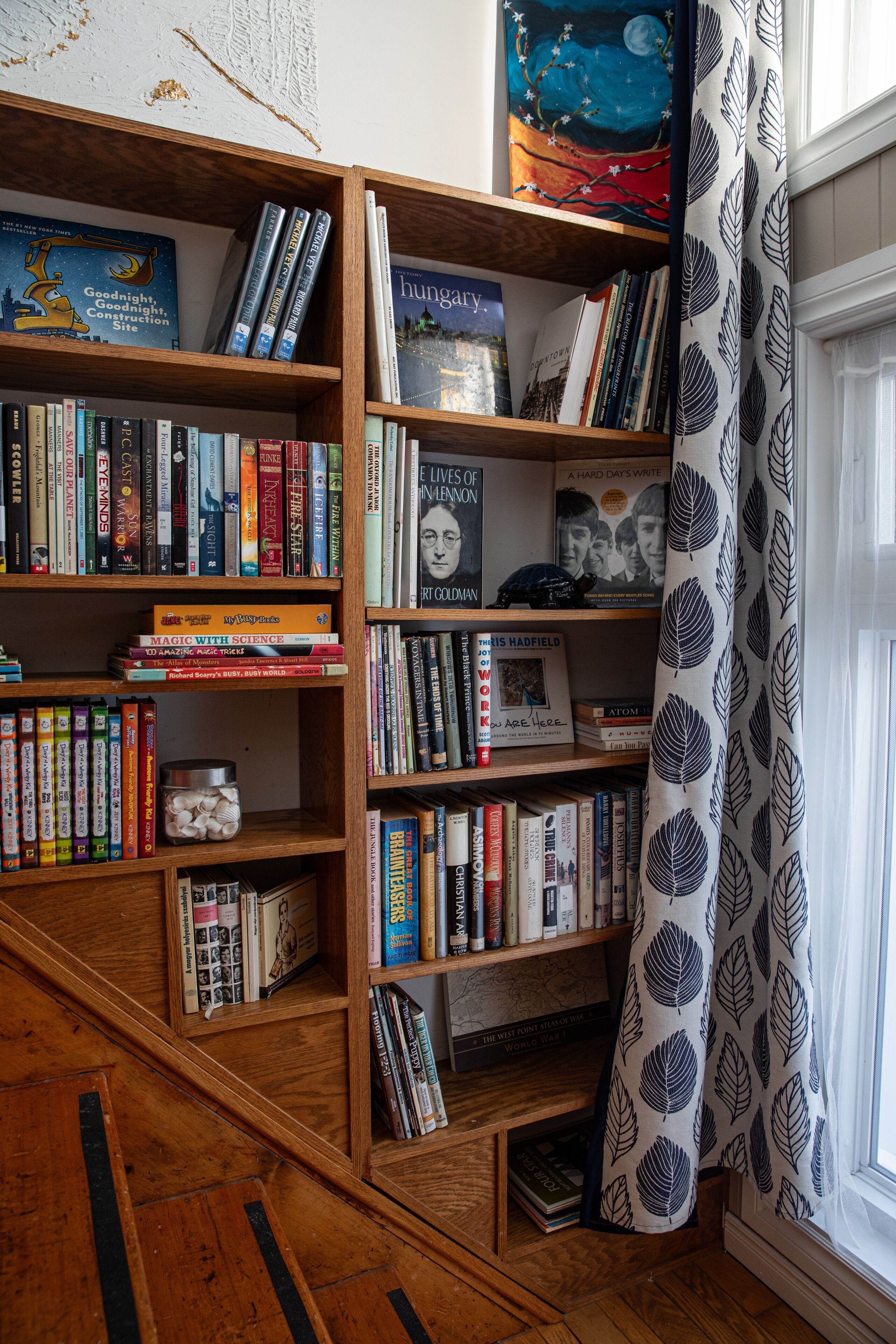 Une bibliothèque remplie de livres et un objet décoratif.