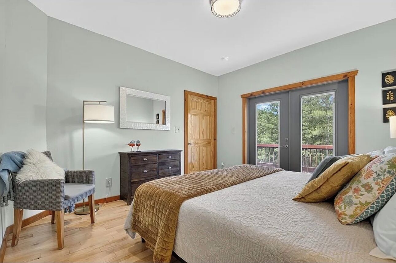 Main floor bedroom with balcony access