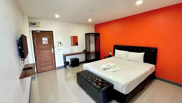 A modern hotel room with a large bed, a wooden desk, a television, and a bathroom. - K2 Green Suphan Buri (Suphan Buri)