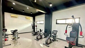 A modern gym with various exercise equipment including treadmills, stationary bikes, and weight machines. - K2 Green Suphan Buri (Suphan Buri)