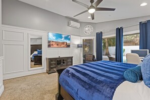 A bedroom with a bed, a desk, and a chair. - Wellness Retreat • Hot Tub + Cold Plunge, Downtown Gilbert! (Gilbert)