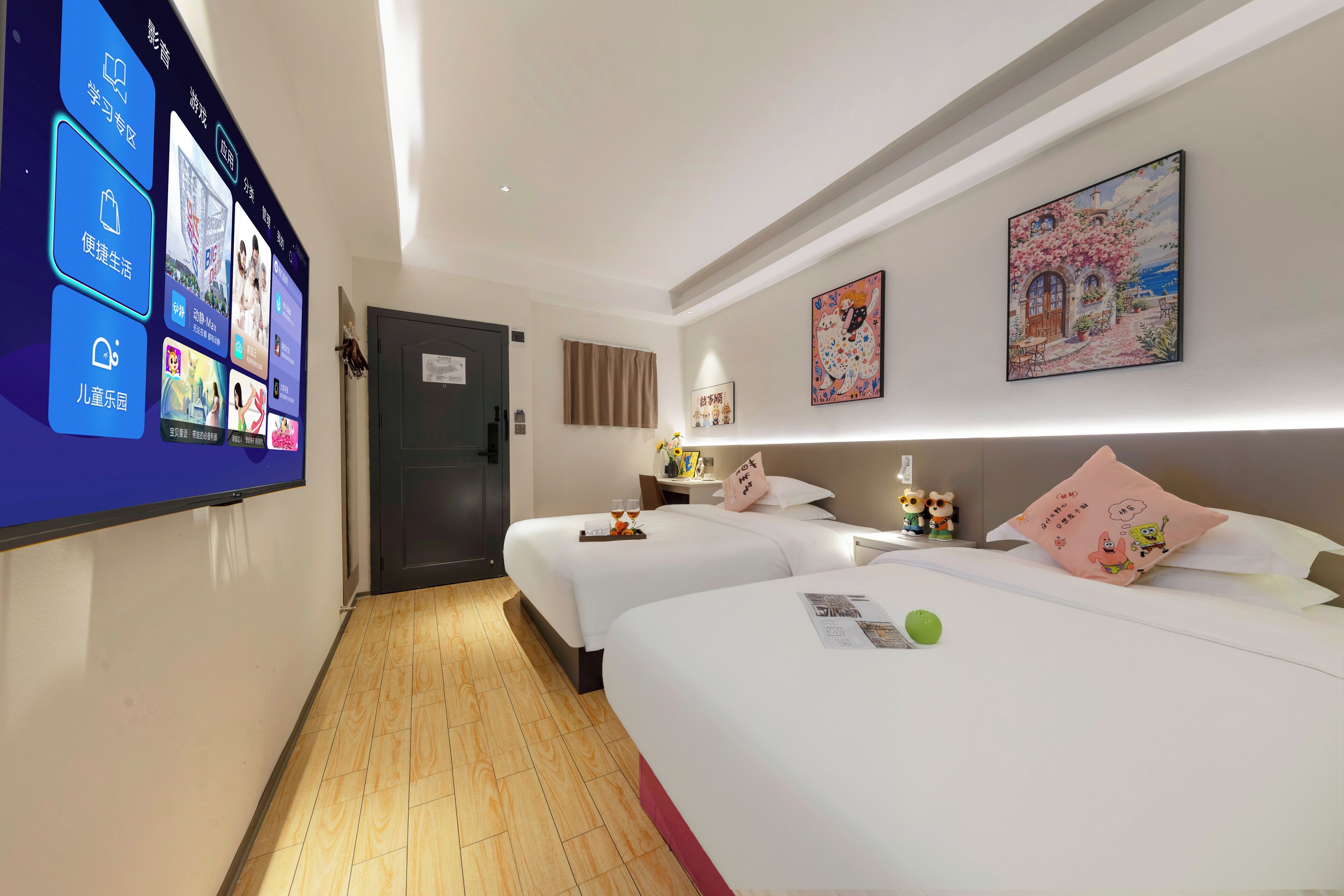 A hotel room with two beds, a flat-screen TV mounted on the wall, and a door leading to the hallway.