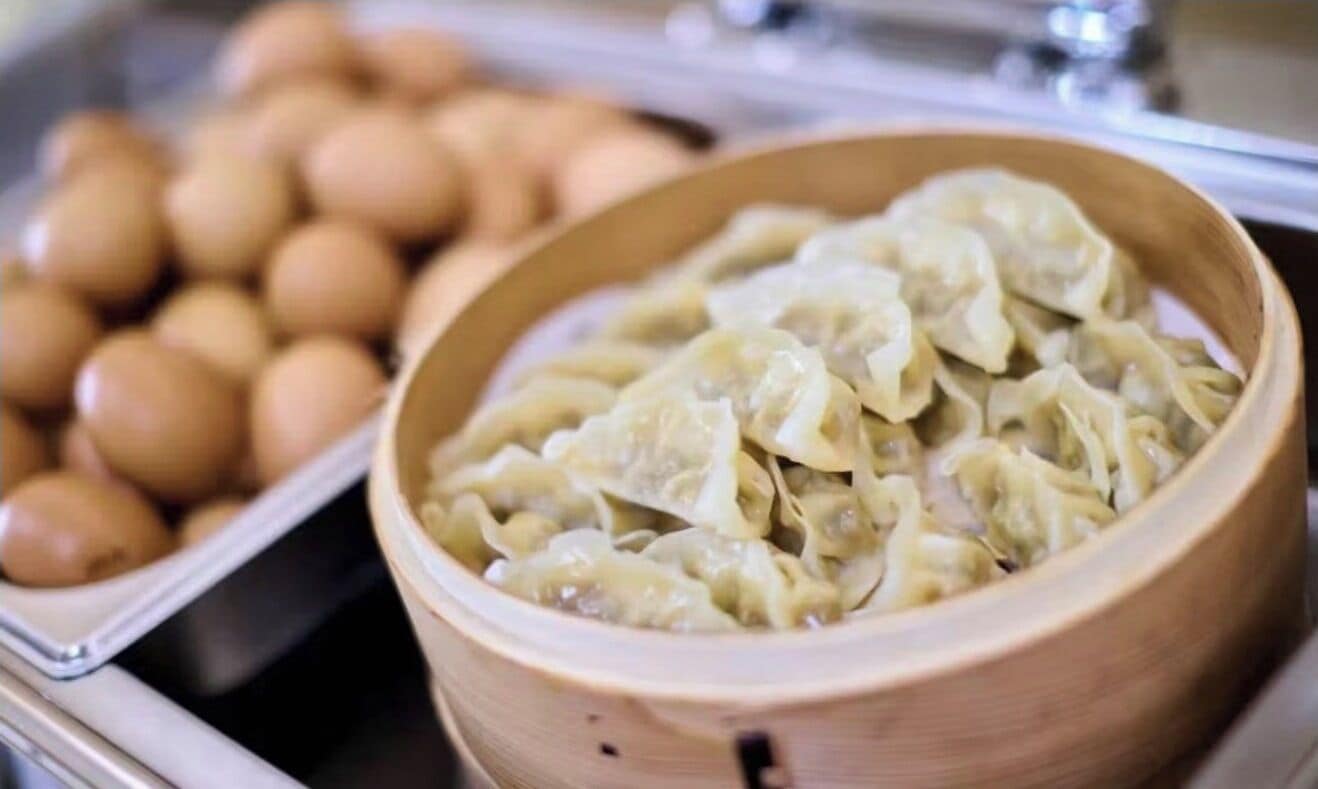 A buffet with dumplings and boiled eggs.
