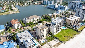 A coastal hotel with multiple buildings, a swimming pool, and a beach area. - Admiralty on Gulf Shore Dr. - 6th flr Beachfront Penthouse - Amazing Gulf views & Stunning Sunsets (Naples)