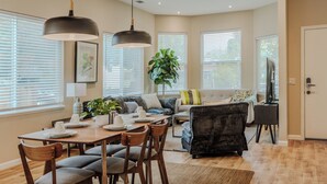 A spacious living area with a dining table, chairs, sofas, and a large plant. - Modern 3BR/2BA – Walk to Japantown, Near SJSU & Tech Hubs (San Jose)
