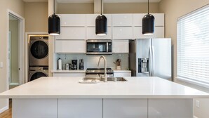 A modern kitchen with a central island, built-in appliances, and pendant lighting. - Modern 3BR/2BA – Walk to Japantown, Near SJSU & Tech Hubs (San Jose)